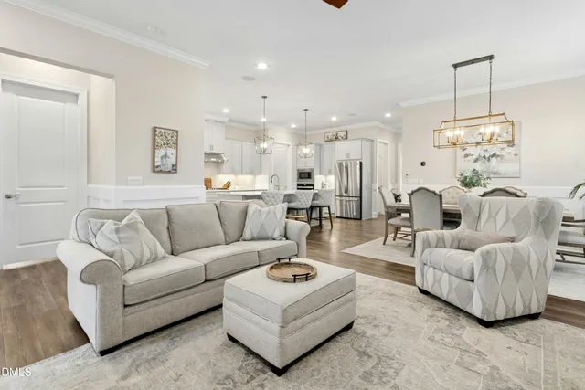a living room with furniture and a chandelier