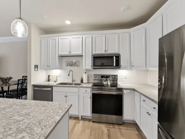 a kitchen with a sink stove and refrigerator