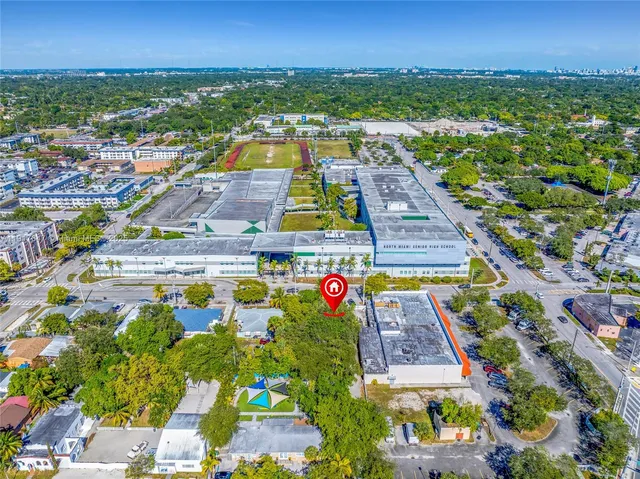 an aerial view of residential houses with outdoor space and swimming pool