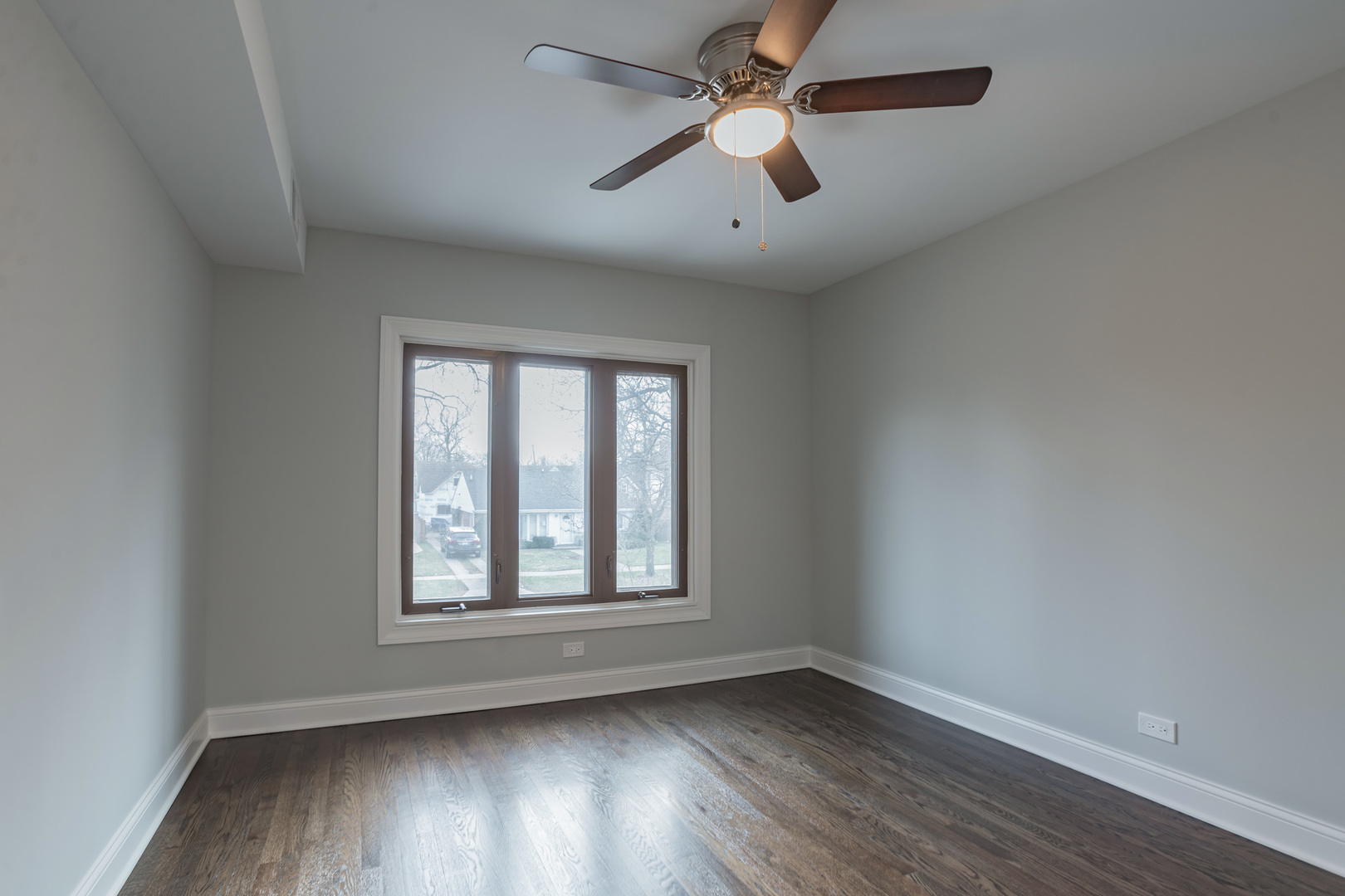 1900 Brophy Avenue Park Ridge, IL 60068 - Photo 15 of 27 an empty room with wooden floor ceiling fan and windows