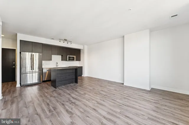 a kitchen with stainless steel appliances a sink and a refrigerator
