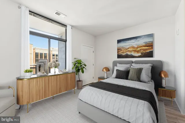 a bedroom with bed and wooden floor