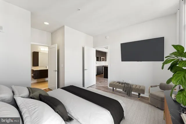 a bedroom with a bed and a flat screen tv