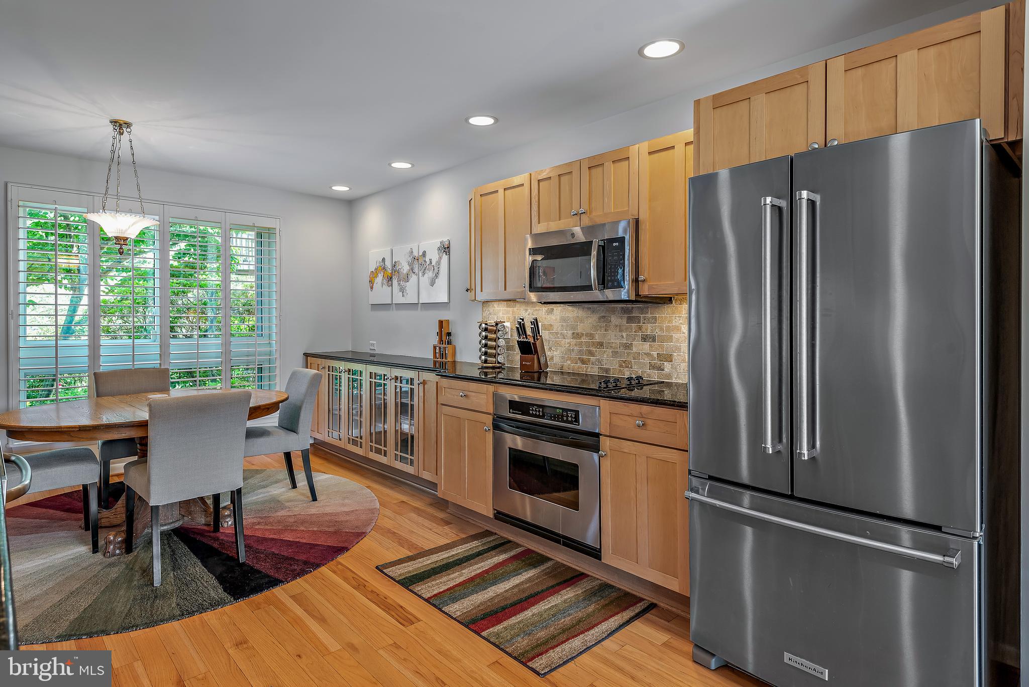 7261 Dockside Lane Columbia, MD 21045 - Photo 21 of 68 a kitchen with stainless steel appliances a refrigerator stove microwave and dining table