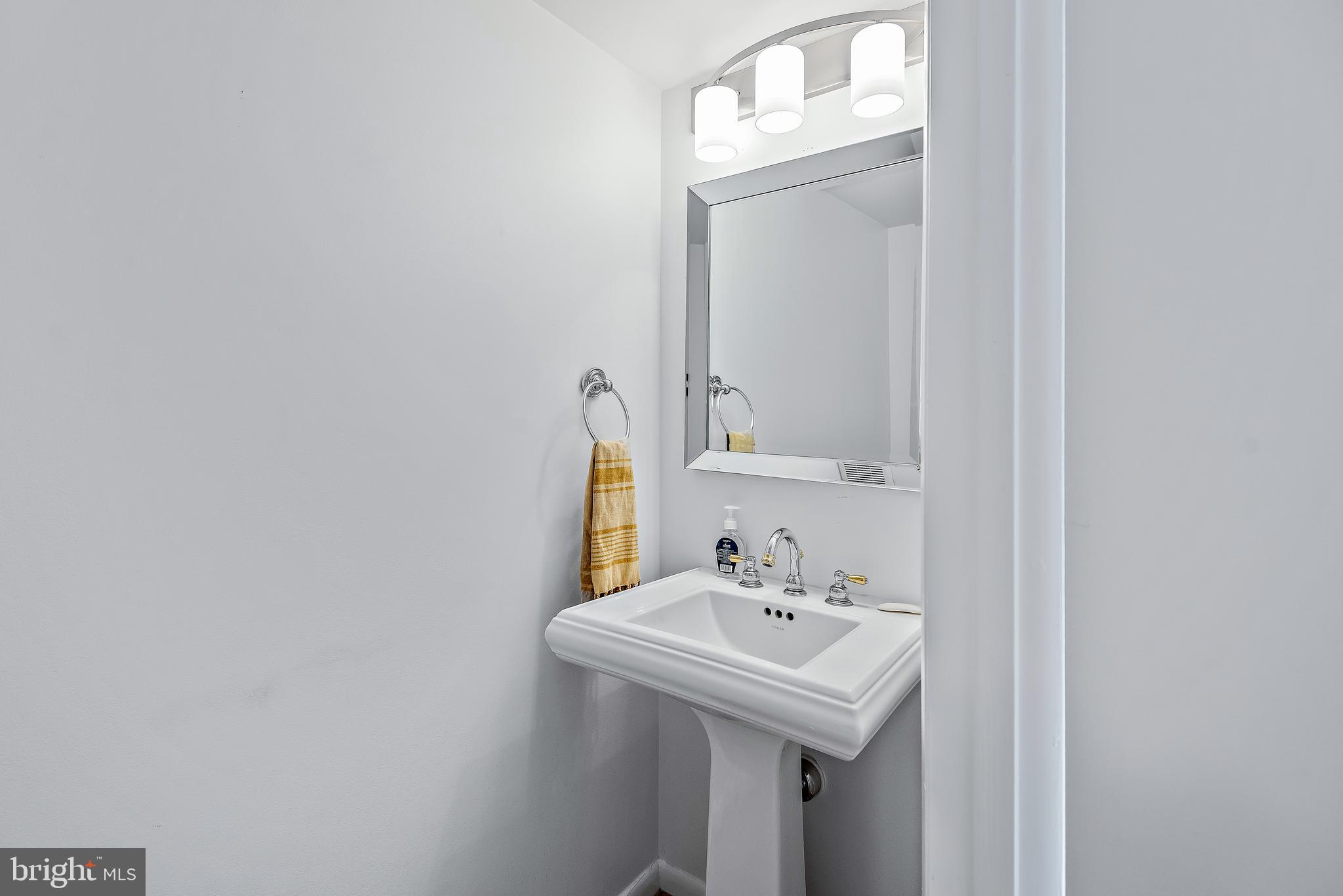 7261 Dockside Lane Columbia, MD 21045 - Photo 26 of 68 a bathroom with a sink and a mirror