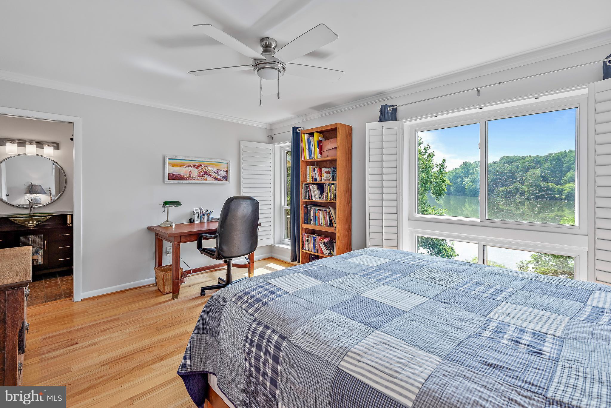 7261 Dockside Lane Columbia, MD 21045 - Photo 28 of 68 a bedroom with a bed a table and a large window