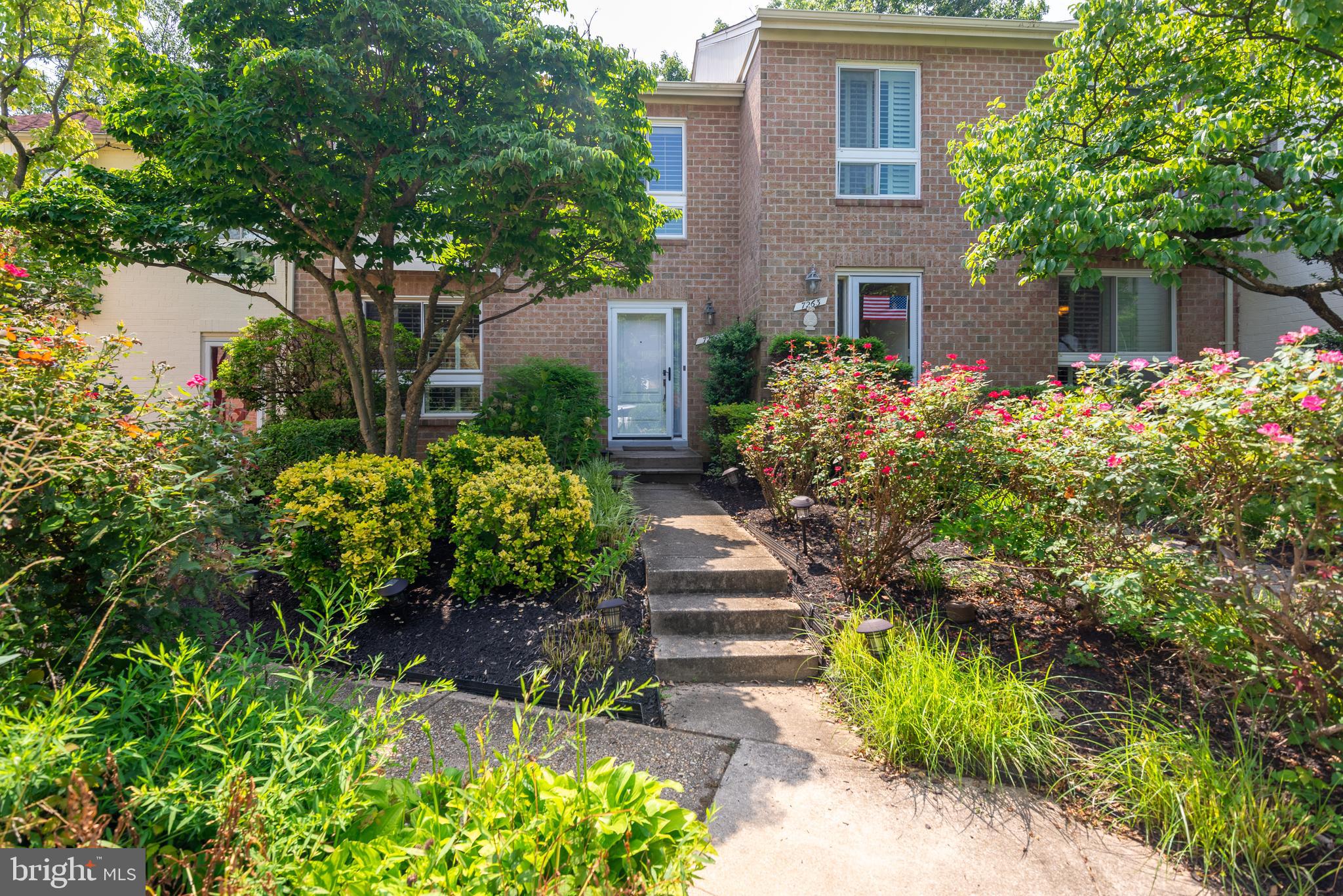 7261 Dockside Lane Columbia, MD 21045 - Photo 3 of 68 a front view of a house with a yard and potted plants