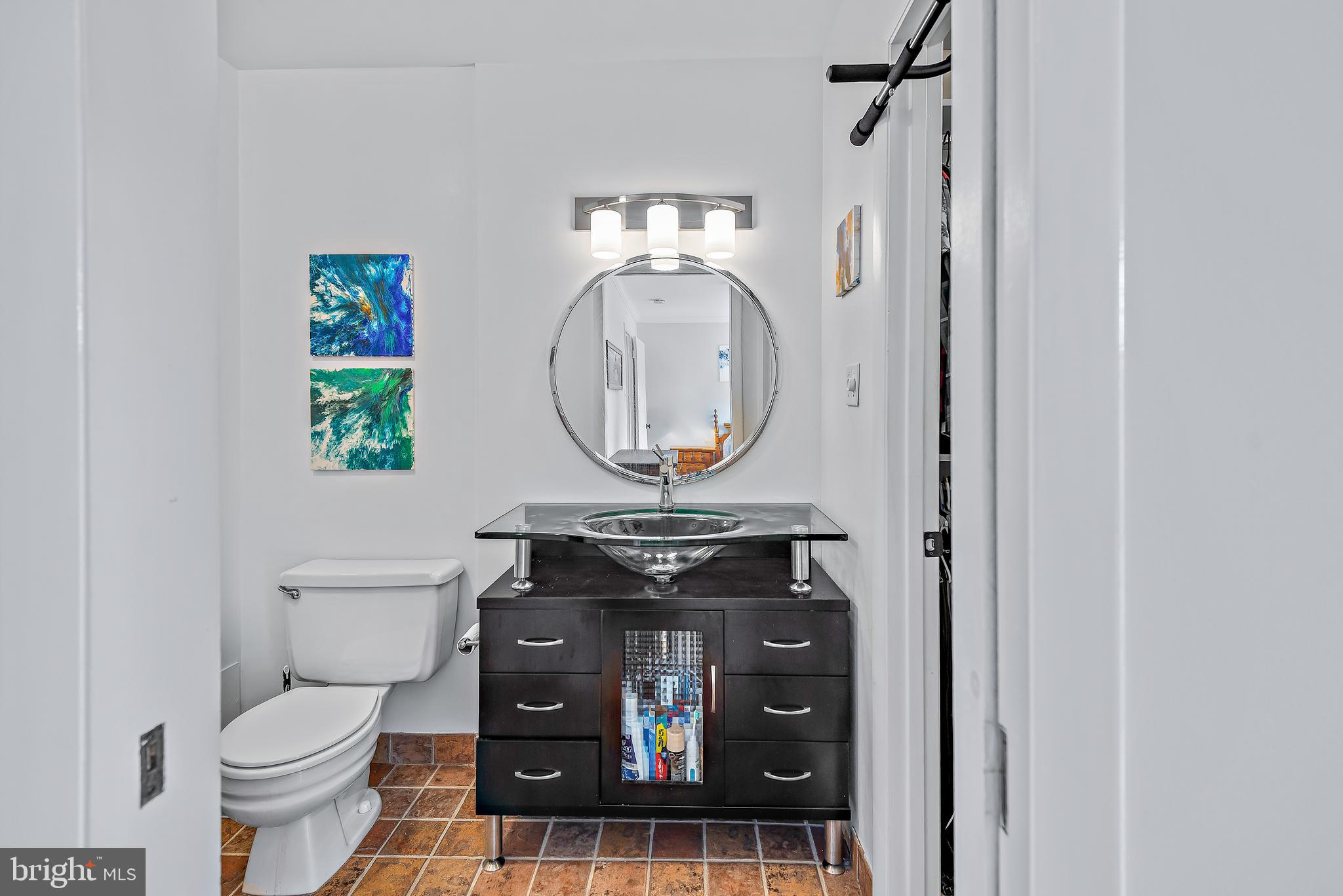 7261 Dockside Lane Columbia, MD 21045 - Photo 34 of 68 a view of bathroom with a toilet a sink and a mirror