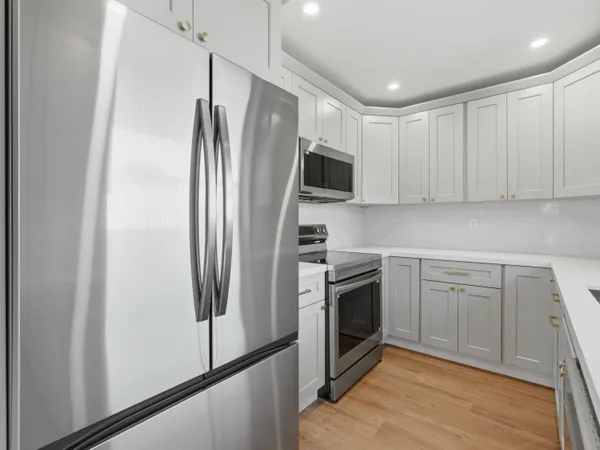 a kitchen with stainless steel appliances a refrigerator stove and sink