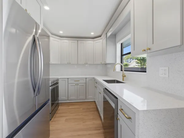 a kitchen with a sink appliances and cabinets