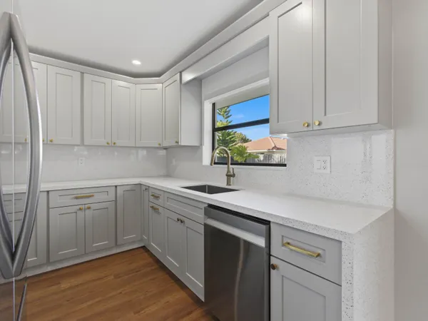 a kitchen with a sink cabinets and window
