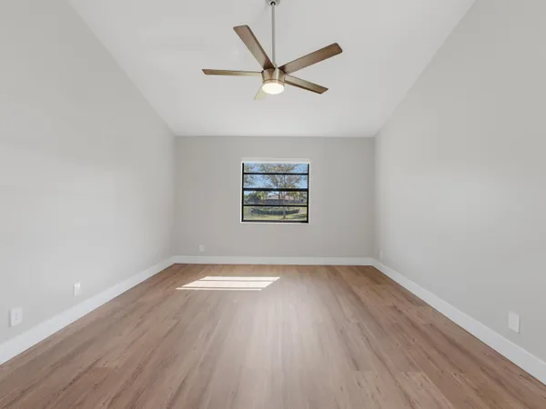 wooden floor in an empty room with a window