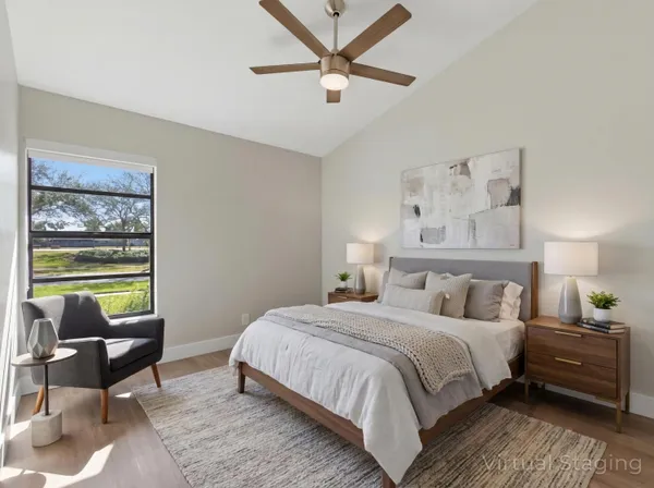 a bedroom with a bed a couch and a window