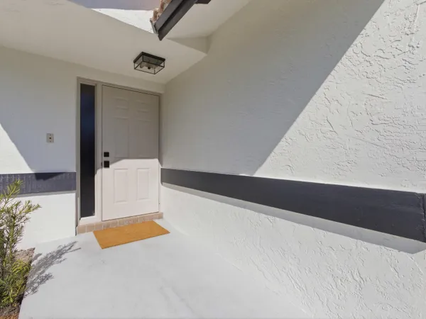 a room with a bed and white walls