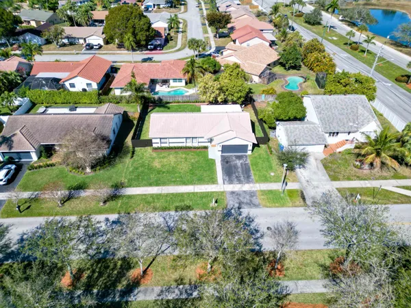 an aerial view of residential houses with outdoor space and street view