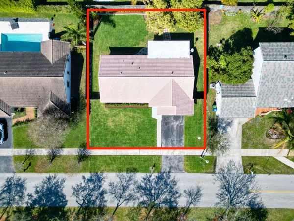 a front view of a house with a garden and yard