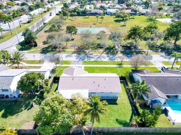 an aerial view of residential houses with outdoor space and swimming pool