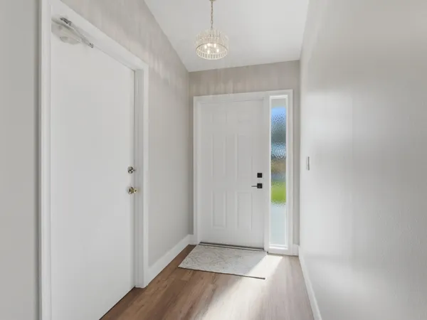 a view of a hallway with wooden floor
