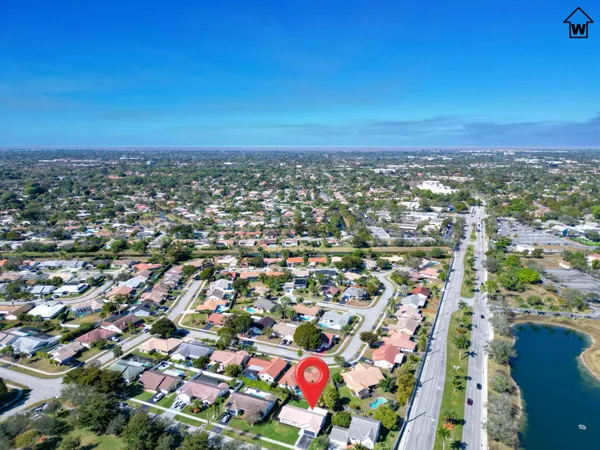 an aerial view of residential houses with outdoor space and street view