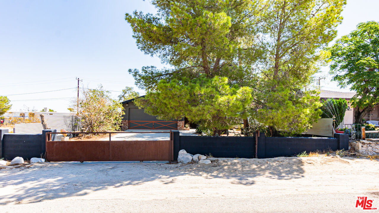 62033 Bonair Road Joshua Tree, CA 92252 - Photo 5 of 53 a view of a terrace with a bench and trees