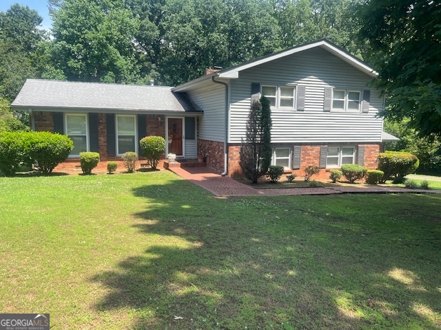 8392 Winston Way Jonesboro, GA 30236 - Photo 1 of 1 a front view of a house with garden and trees