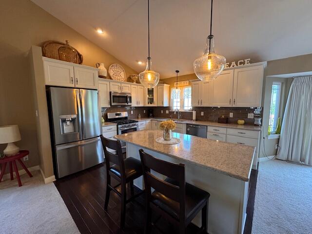 2307 Legend Circle Chesterton, IN 46304 - Photo 4 of 24 a kitchen with stainless steel appliances granite countertop a refrigerator a sink dishwasher a stove a dining table and chairs with wooden floor