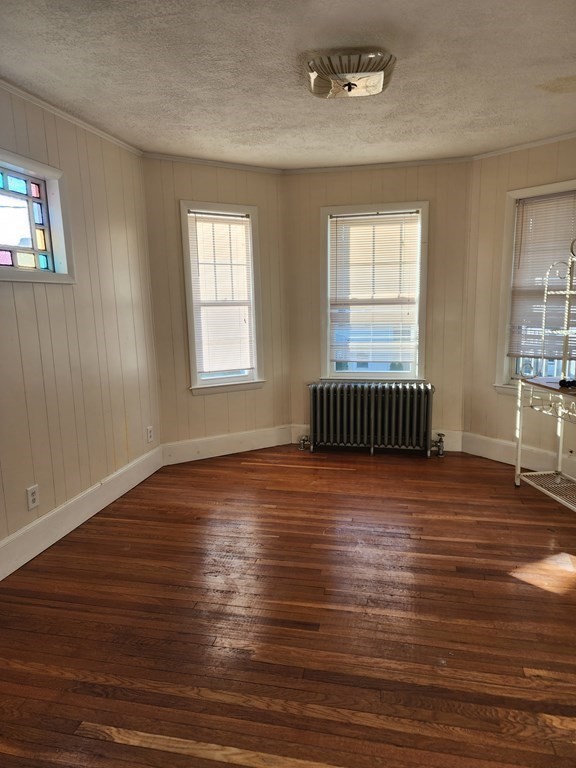 57 Austin Street, Unit 2 Boston, MA 02136 - Photo 6 of 17 an empty room with wooden floor and windows