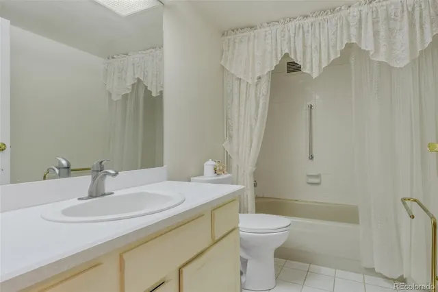 a bathroom with a sink toilet vanity and shower