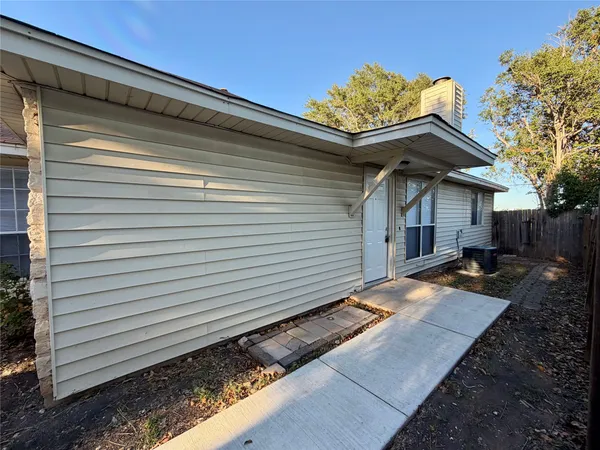 a view of house with backyard and sitting area