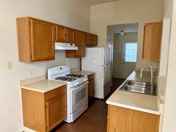 a kitchen with a stove and a refrigerator