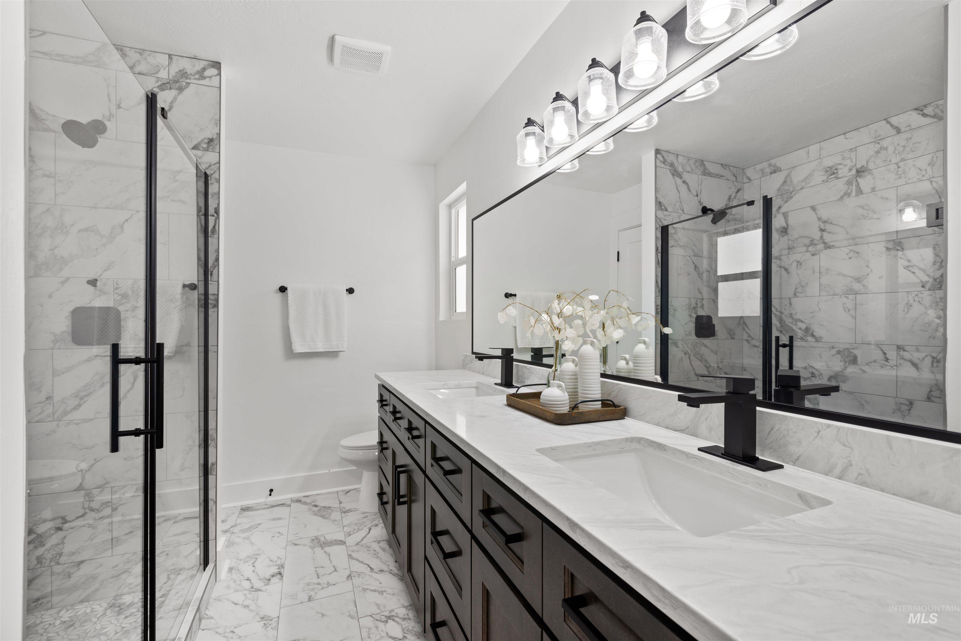 29862 Emmett Road Caldwell, ID 83607 - Photo 22 of 45 Full bath featuring double vanity, a marble finish shower, and light marble finish flooring