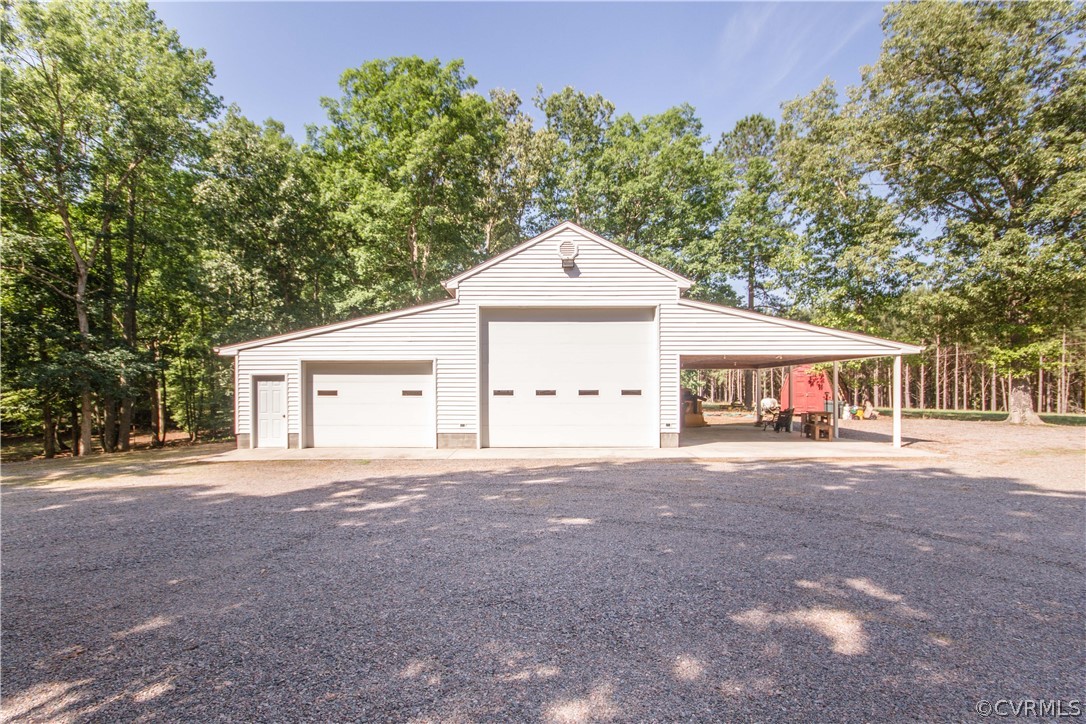 19880 Turkey Ridge Road Carson, VA 23830 - Photo 12 of 20 a front view of a house with a yard and garage