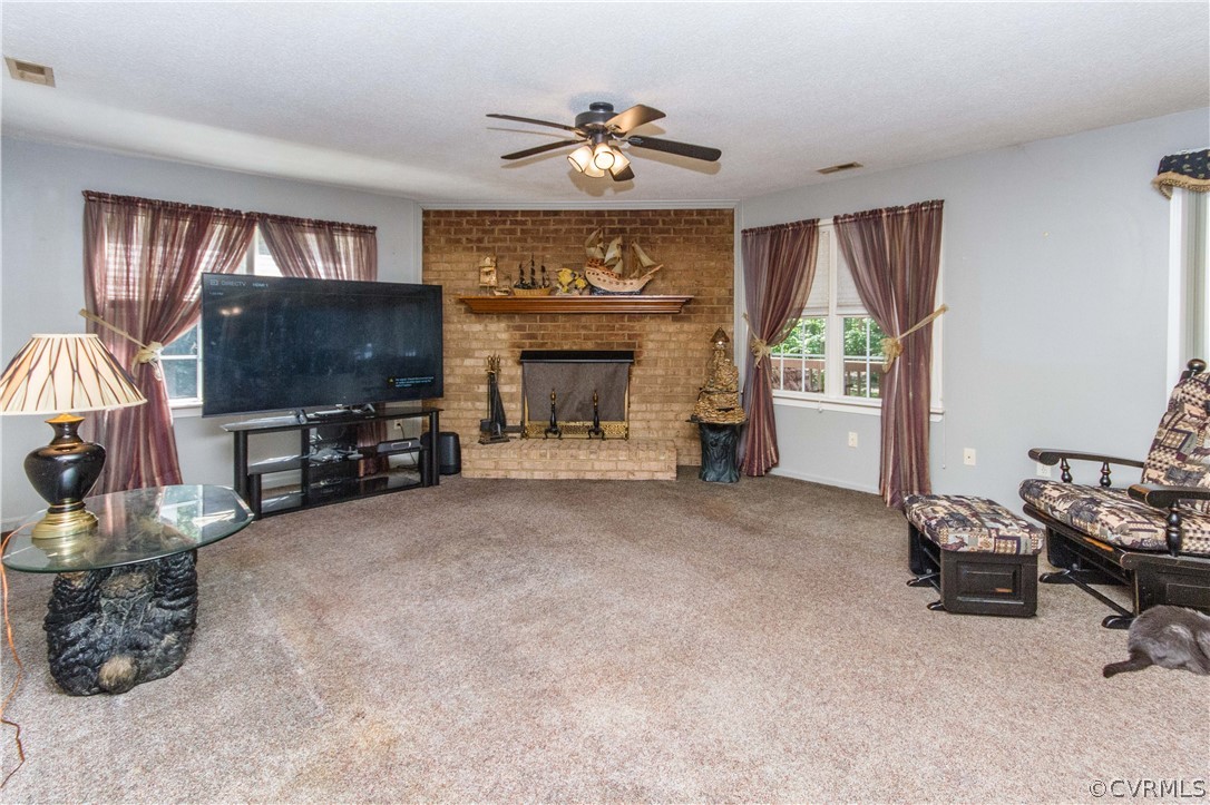 19880 Turkey Ridge Road Carson, VA 23830 - Photo 8 of 20 a living room with furniture a fireplace and a flat screen tv