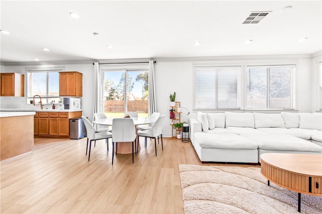 6310 Cosmos Street Eastvale, CA 92880 - Photo 13 of 71 a living room with furniture and a large window
