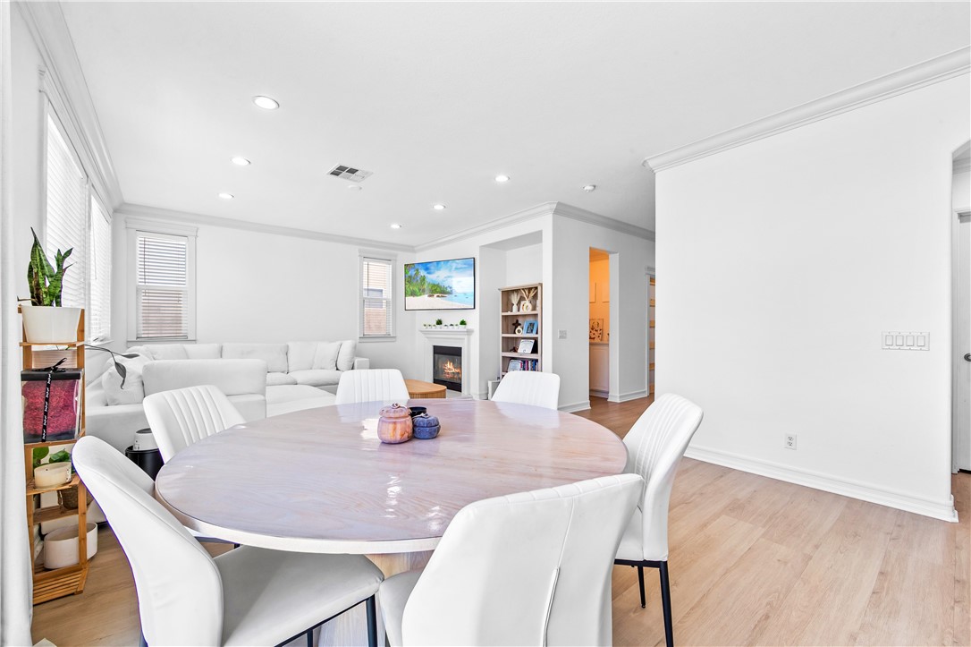 6310 Cosmos Street Eastvale, CA 92880 - Photo 15 of 71 a dining room with furniture and wooden floor