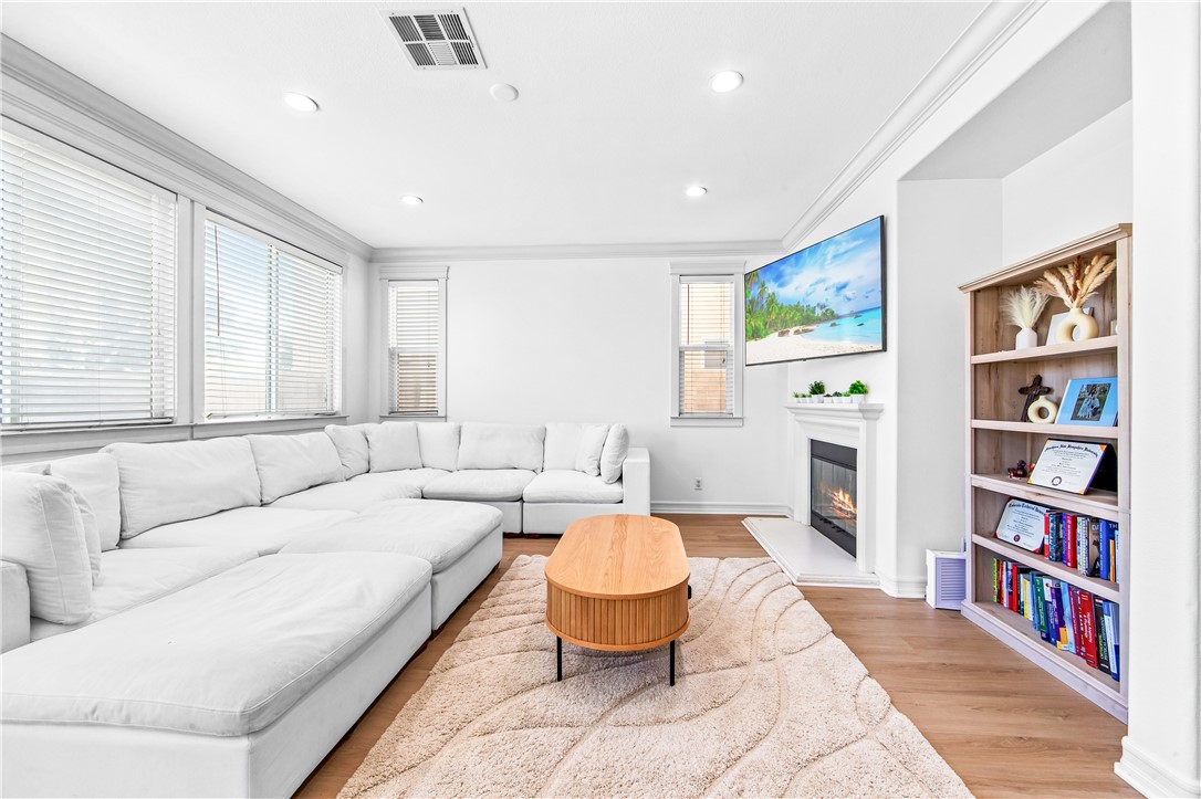 6310 Cosmos Street Eastvale, CA 92880 - Photo 16 of 71 a living room with furniture and a book shelf