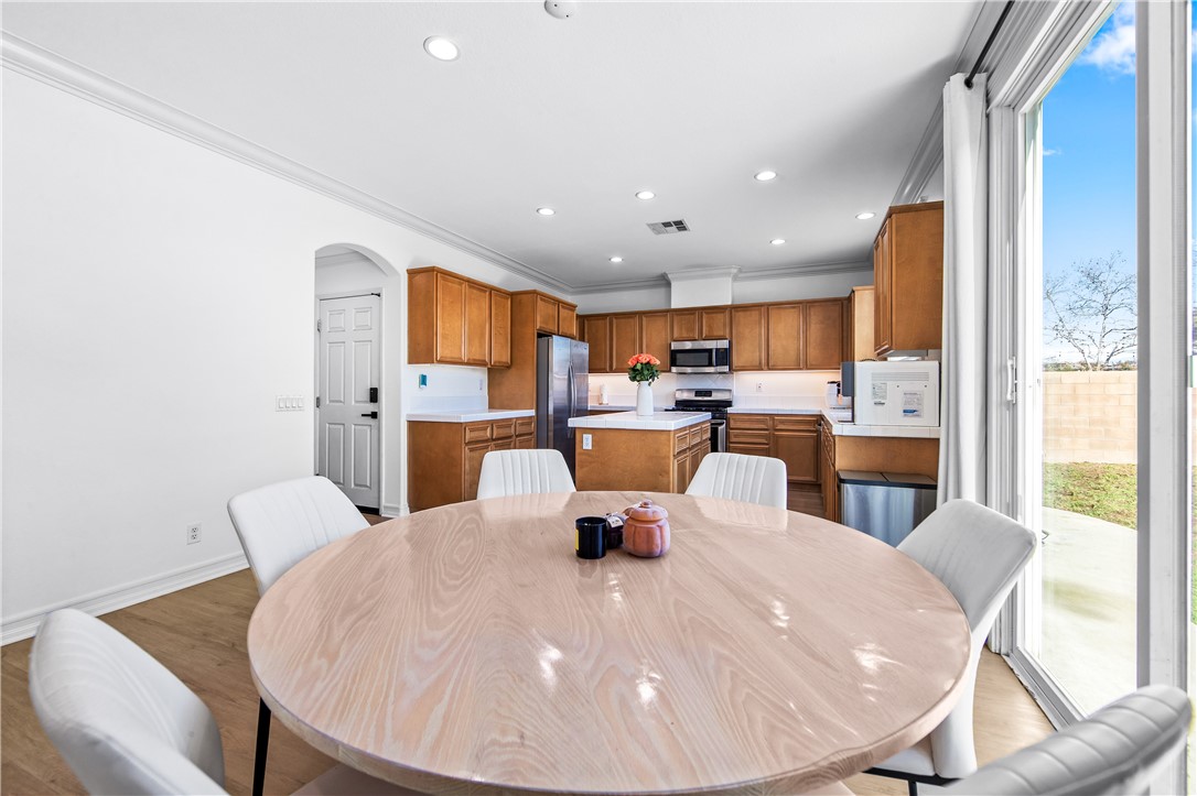 6310 Cosmos Street Eastvale, CA 92880 - Photo 19 of 71 a dining room with a table chairs and entryway