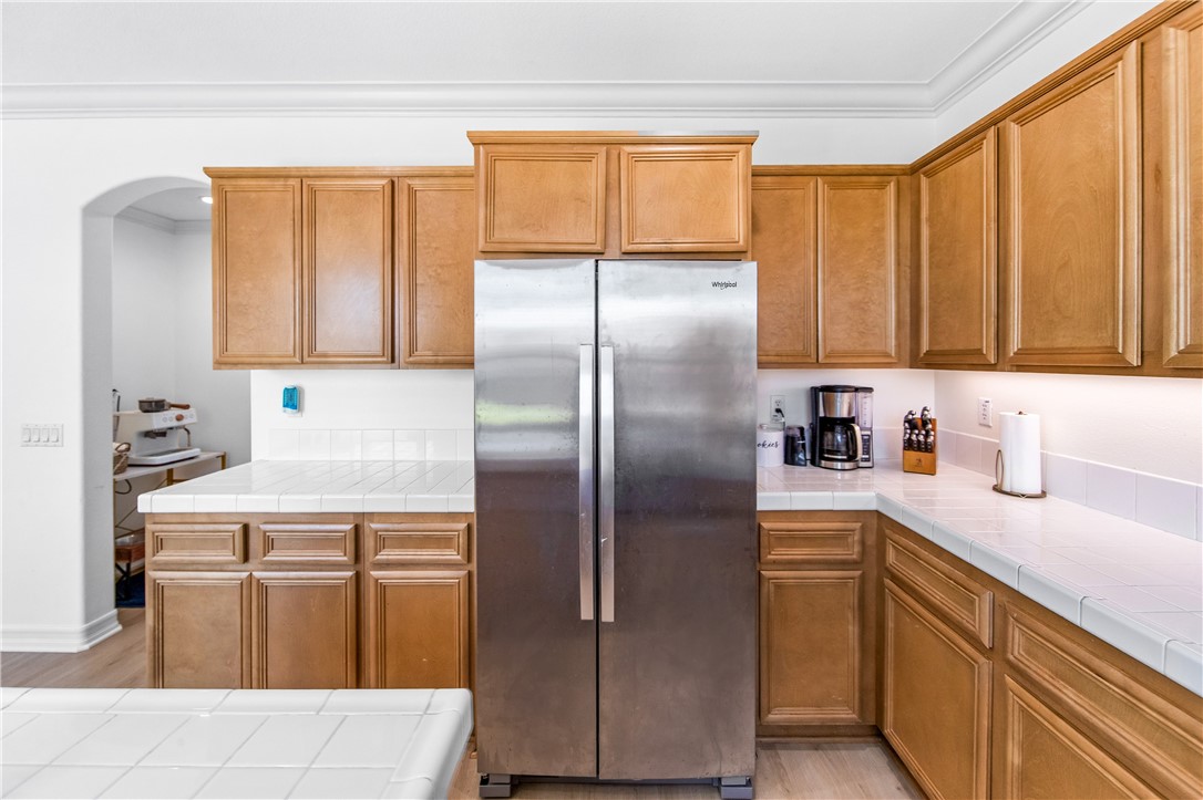 6310 Cosmos Street Eastvale, CA 92880 - Photo 29 of 71 a kitchen with a refrigerator sink and cabinets