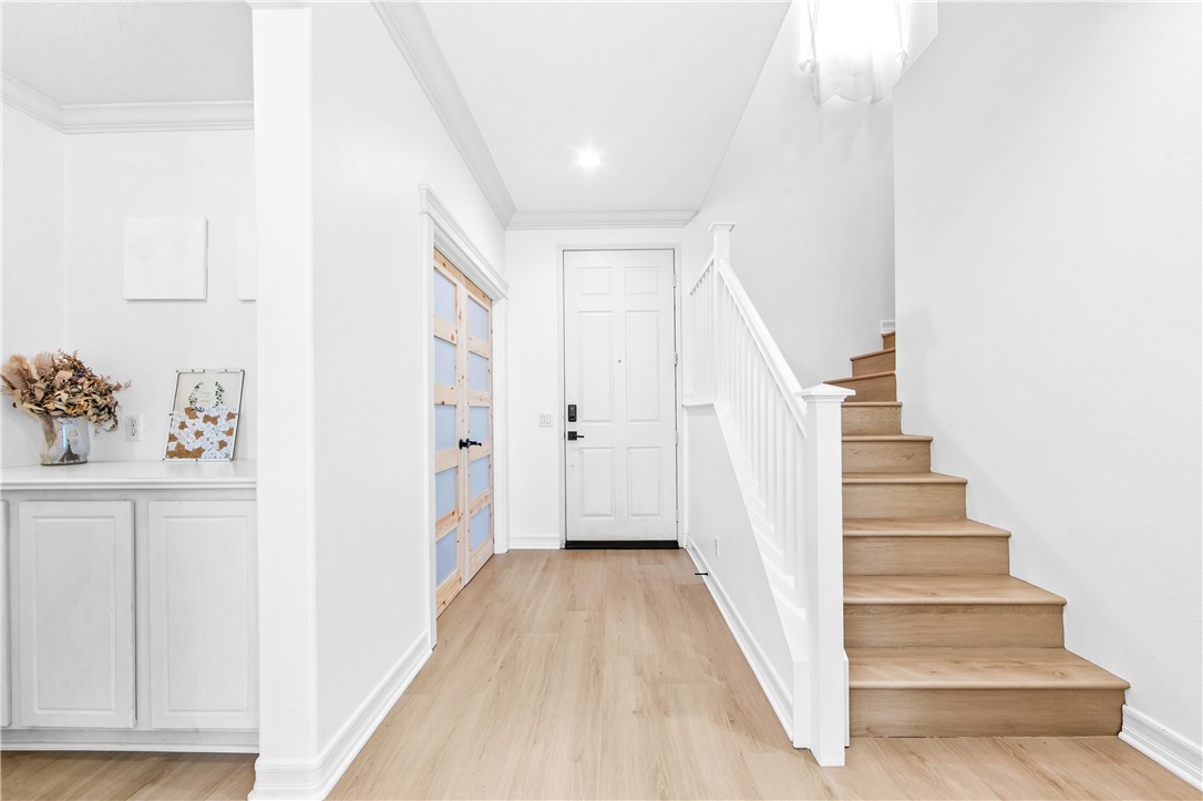 6310 Cosmos Street Eastvale, CA 92880 - Photo 30 of 71 a view of a hallway with wooden floor and entryway