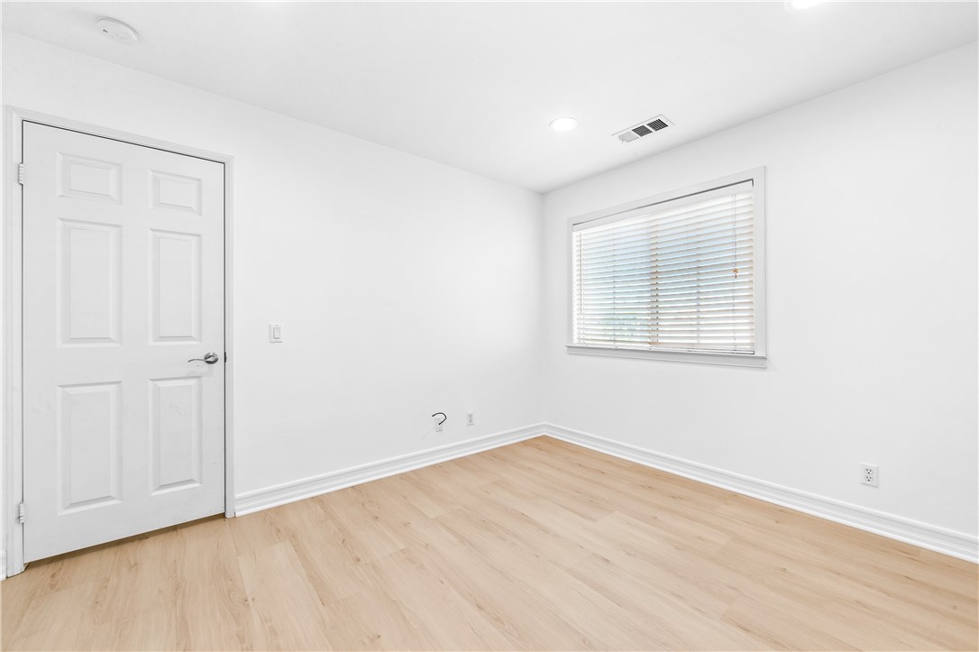6310 Cosmos Street Eastvale, CA 92880 - Photo 38 of 71 a view of an empty room with wooden floor