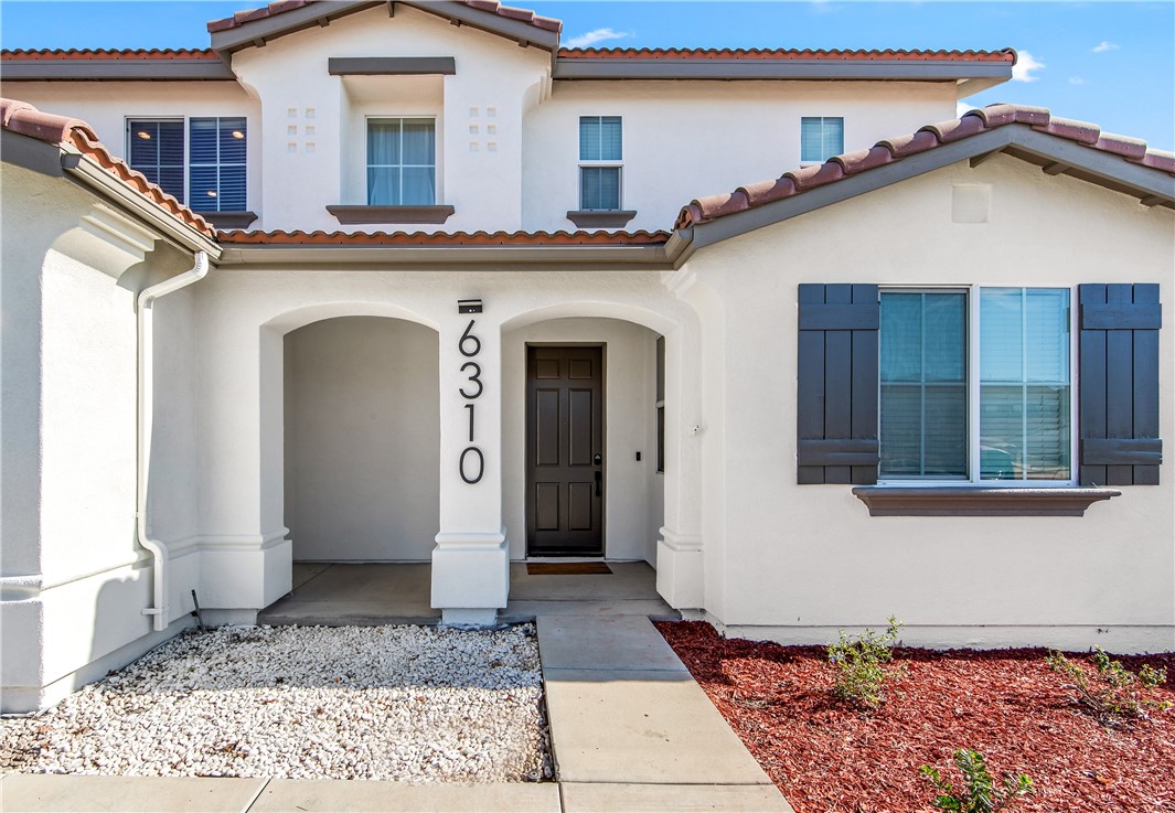 6310 Cosmos Street Eastvale, CA 92880 - Photo 4 of 71 a front view of a house with a porch