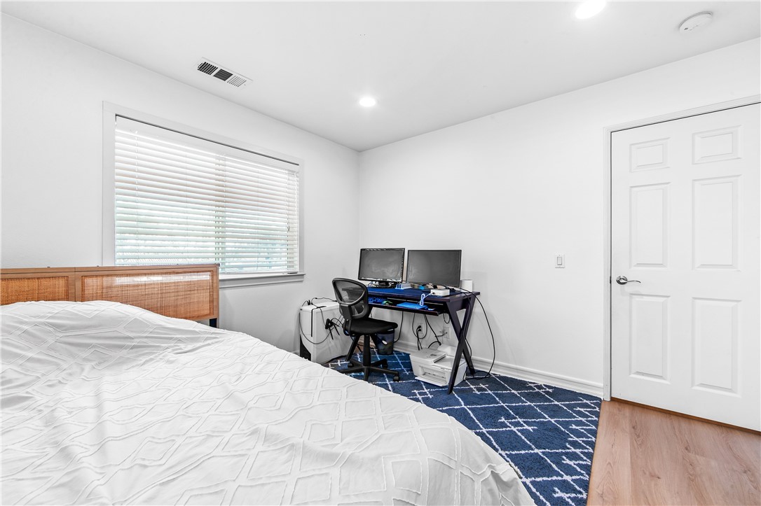 6310 Cosmos Street Eastvale, CA 92880 - Photo 41 of 71 a bedroom with a bed and a computer on the desk