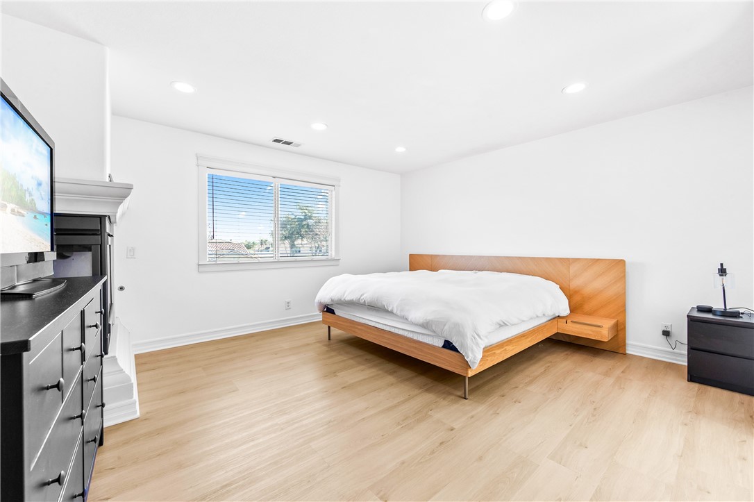 6310 Cosmos Street Eastvale, CA 92880 - Photo 49 of 71 a bedroom with a bed and a flat screen tv