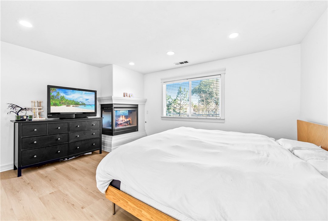 6310 Cosmos Street Eastvale, CA 92880 - Photo 50 of 71 a bedroom with a bed and a flat screen tv