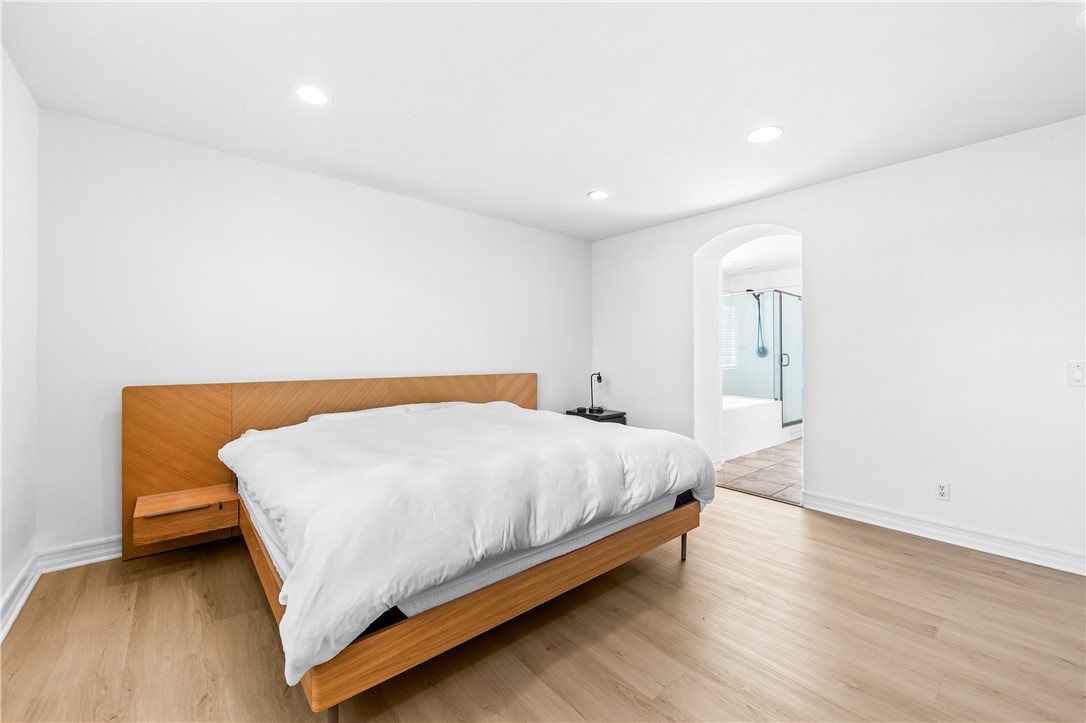 6310 Cosmos Street Eastvale, CA 92880 - Photo 51 of 71 a bedroom with a bed and a night stand