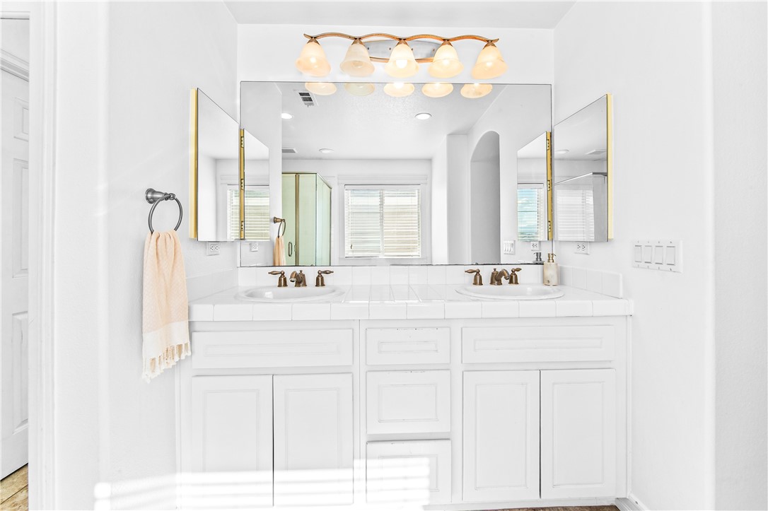 6310 Cosmos Street Eastvale, CA 92880 - Photo 55 of 71 a bathroom with a sink vanity and a mirror