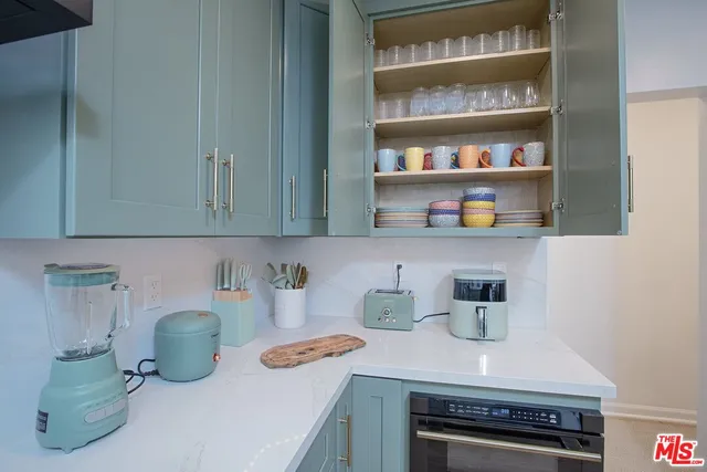 a kitchen with a refrigerator and washer