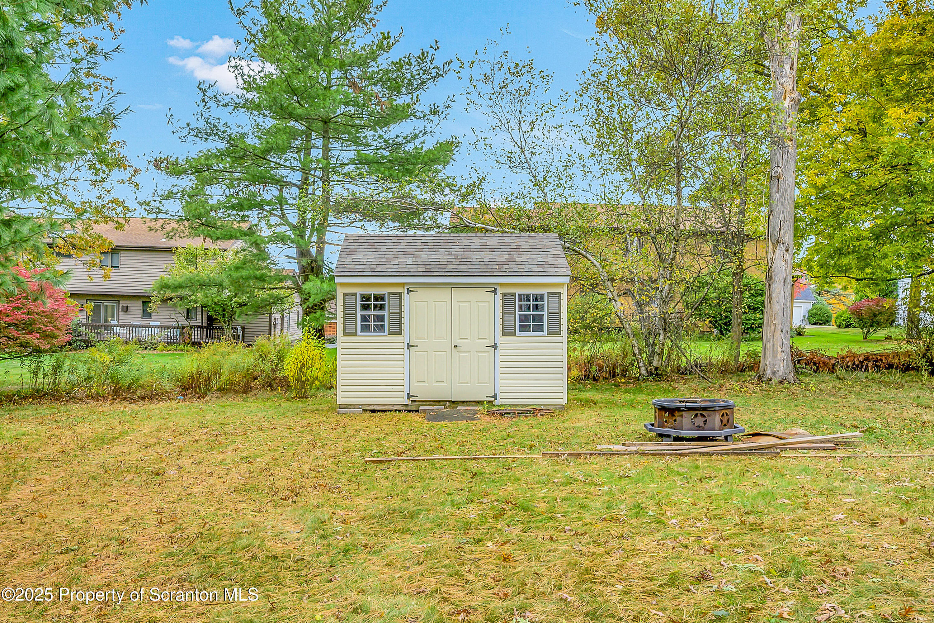 1002 Pheasant Run Road Clarks Summit, PA 18411 - Photo 12 of 53 a backyard of a house with plants and tree