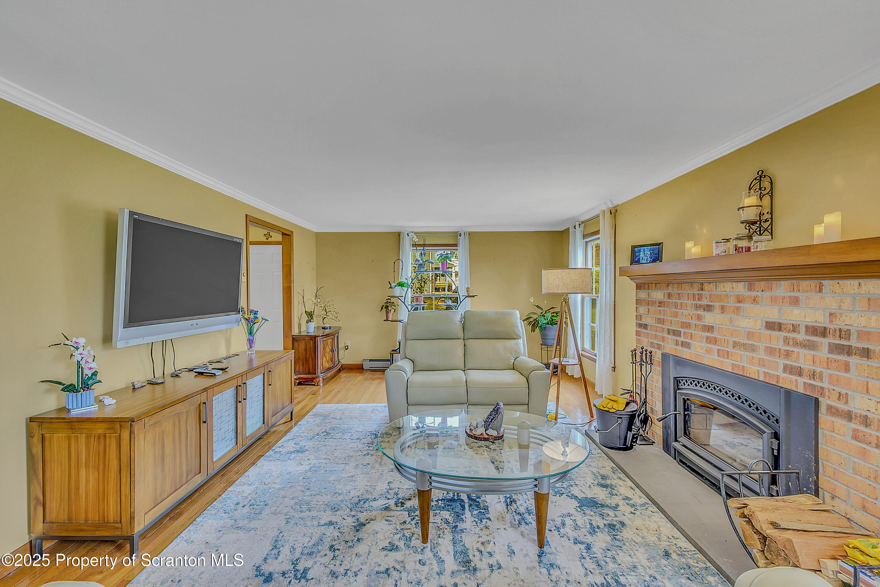 1002 Pheasant Run Road Clarks Summit, PA 18411 - Photo 14 of 53 a living room with furniture a flat screen tv and a fireplace