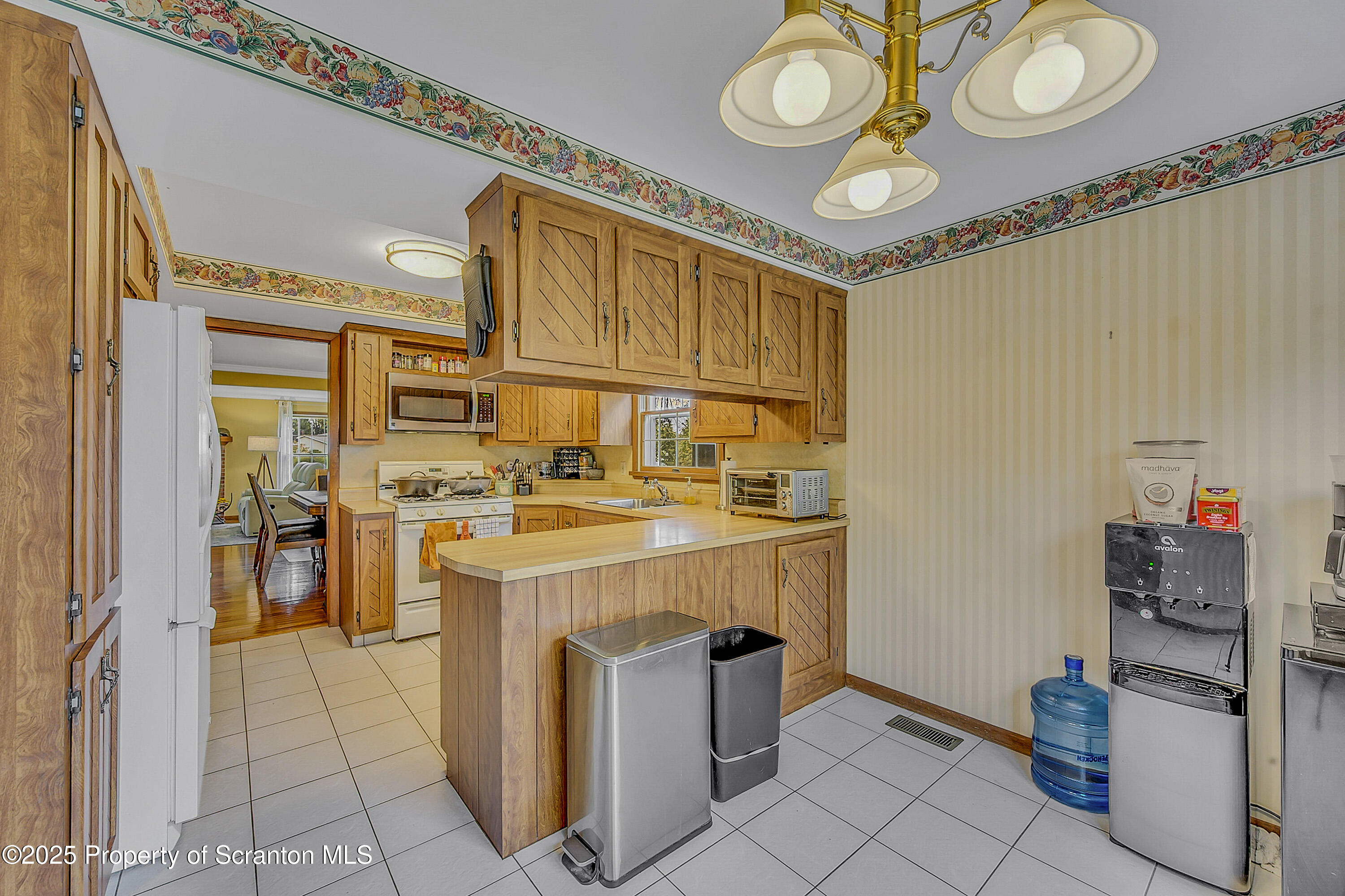 1002 Pheasant Run Road Clarks Summit, PA 18411 - Photo 25 of 53 a kitchen with a stove and a refrigerator